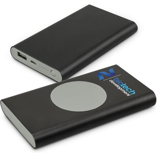 A black wireless charging power bank with a USB port and a circular charging pad, featuring a logo.