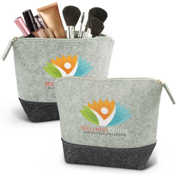 A green cosmetic bag featuring a darker base, filled with makeup products and brushes. It has a logo on the front.