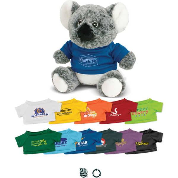 A grey koala plush toy wearing a blue shirt, surrounded by various brightly coloured t-shirts in different shades.