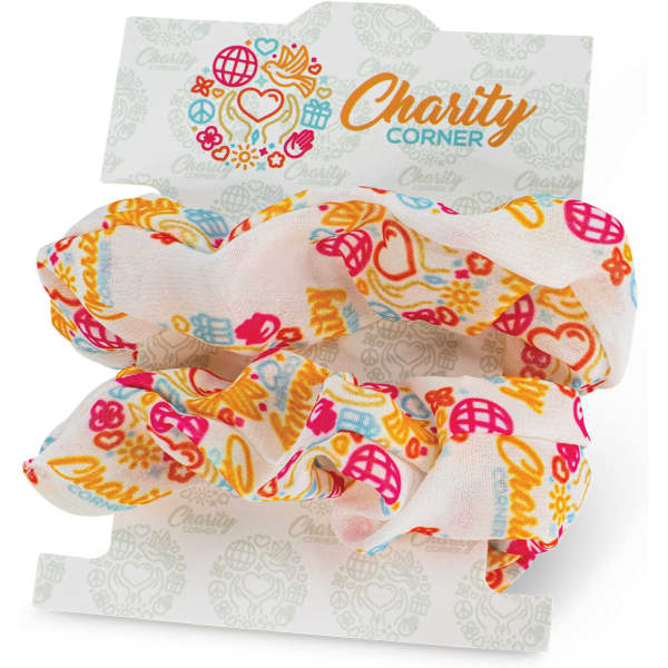 A set of two hair scrunchies in vibrant floral patterns, featuring shades of pink, orange, and cream, displayed on a card.