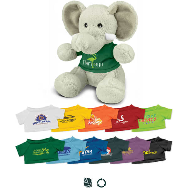 A grey elephant plush toy wearing a green shirt, surrounded by various T-shirts in different colours.
