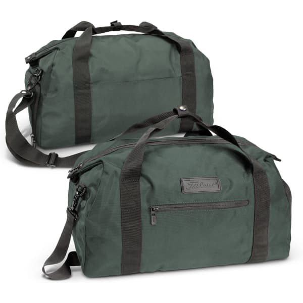 A dark green duffle bag with black straps, featuring a zippered pocket and a logo on the front.