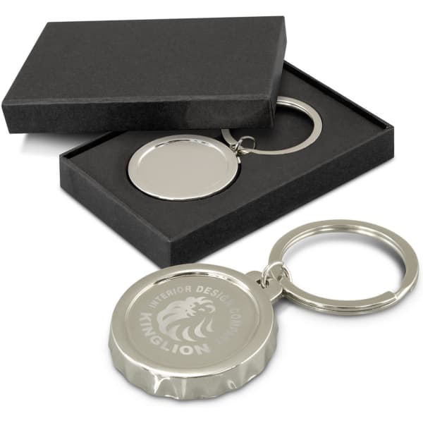 A drink bottle opener key ring in silver with a branded logo, displayed in a black gift box.
