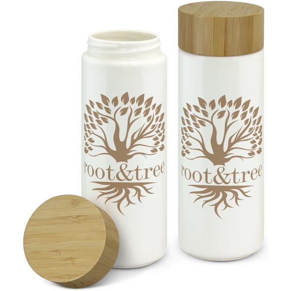 A drink bottle with a white ceramic body, bamboo lid, and a tree design featuring a logo.