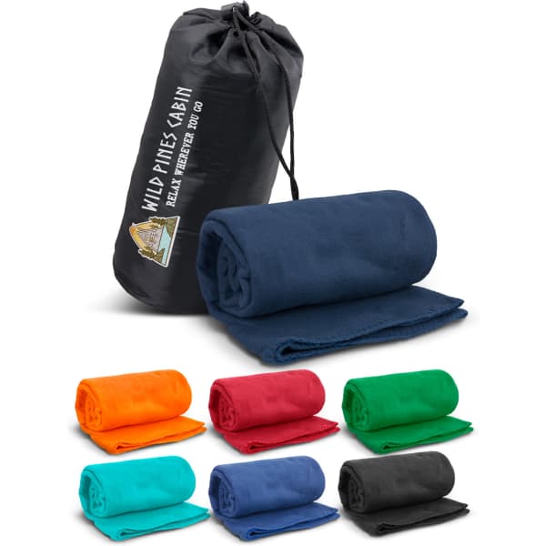 A rolled navy fleece blanket and a black carry bag, surrounded by fleece blankets in various colours.
