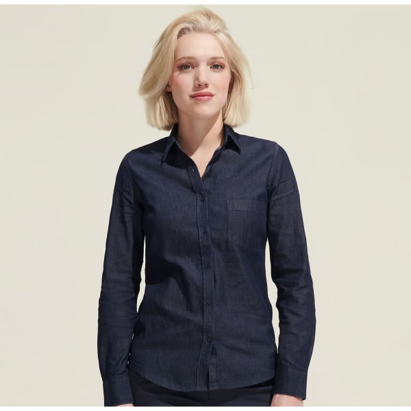 A women's denim button-up shirt in a dark blue colour with a single chest pocket and a fitted design.