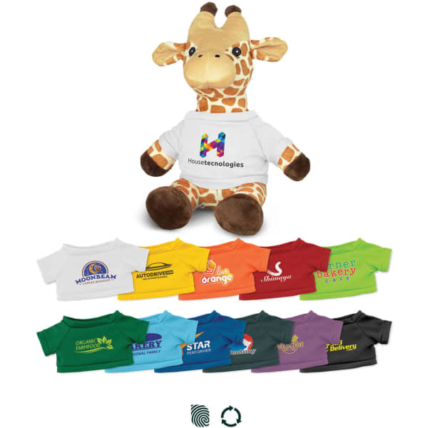 A giraffe plush toy in brown and yellow, wearing a white shirt with branding, surrounded by assorted colourful T-shirts.