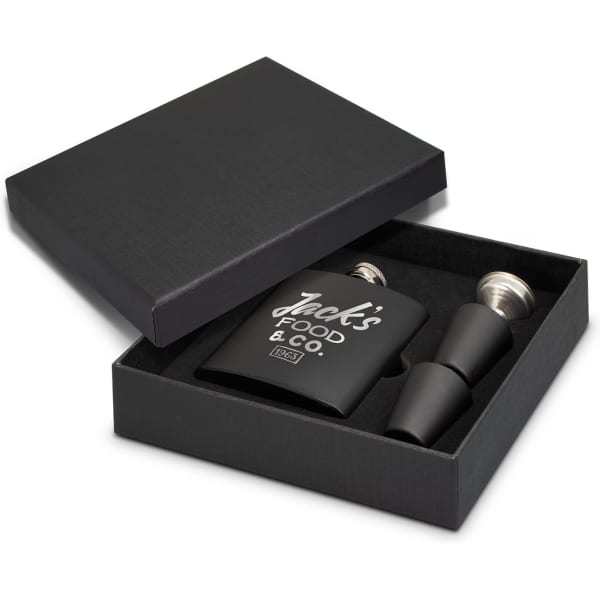 A black hip flask gift set in a box, featuring a flask, two pourers, and a logo.