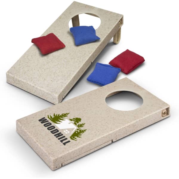 A cornhole game featuring two wooden boards with a speckled finish and one logo, along with red and blue bean bags.