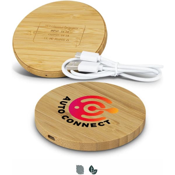 A round bamboo wireless charger with a logo, featuring a white charging cable. The wood has a natural finish.