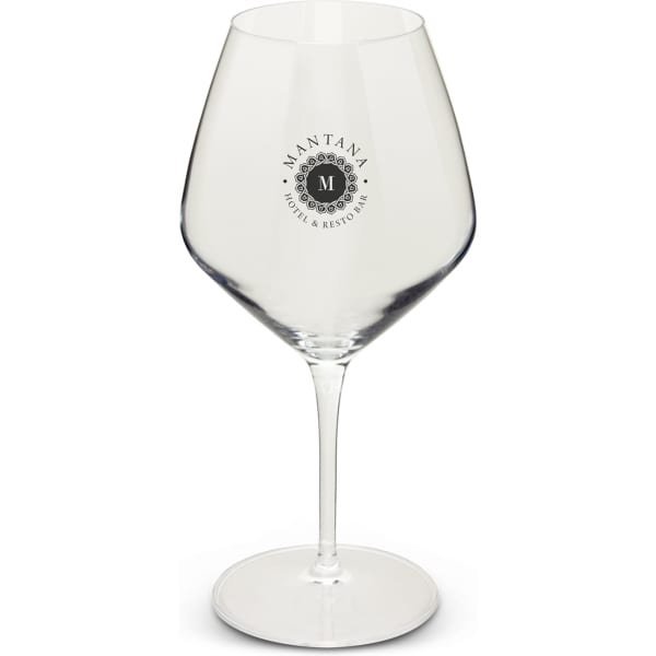 A clear glass wine glass with a large bowl and a long stem, featuring a logo on one side.