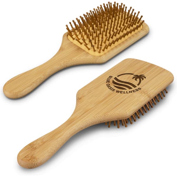 A bamboo hair brush with a wooden handle and a branded design, featuring rounded pins for detangling.