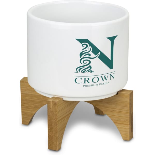 A white planter with a bamboo base, featuring a logo on the front.