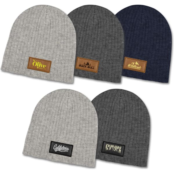A collection of cable knit beanies in light grey, dark grey, navy, and olive, each with a unique patch.