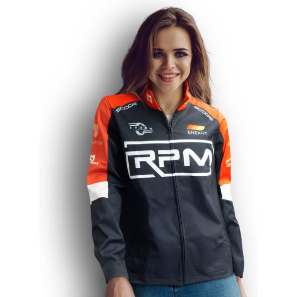 A woman in a black and orange softshell jacket with a logo on the front and sleeves.