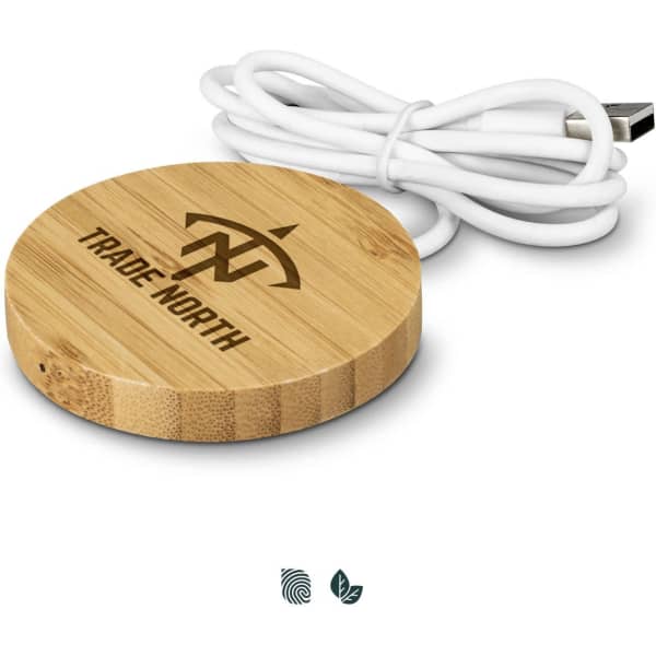 A bamboo wireless charger with a white USB cable, featuring a circular design and a logo engraved on top.