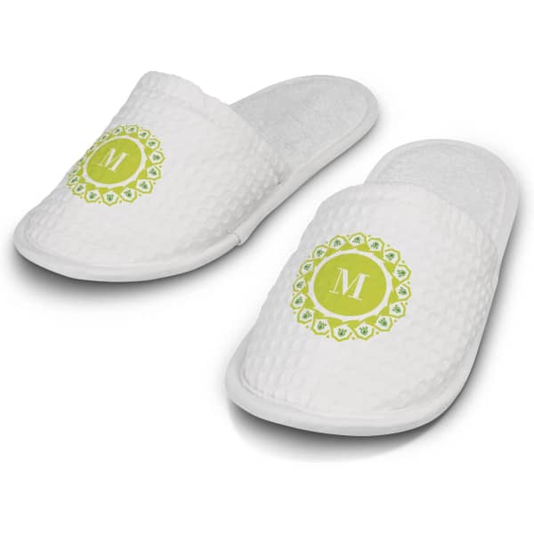 White waffle slippers featuring a circular green design with a letter 