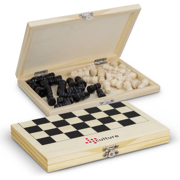 A wooden travel chess set featuring black and white pieces, housed in a checkered-patterned box with a logo.