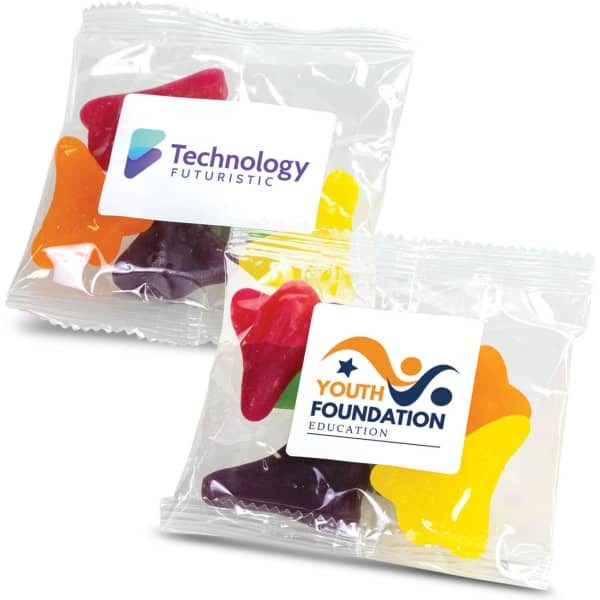 A clear plastic bag containing assorted gummy shapes in red, yellow, green, orange, and purple, with two labels.