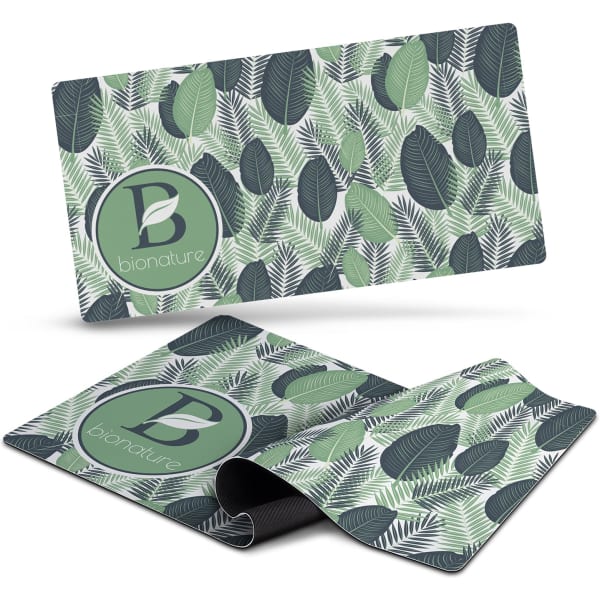 A green and grey desk mat featuring a leaf pattern and a logo. The mat lies flat and is flexible.