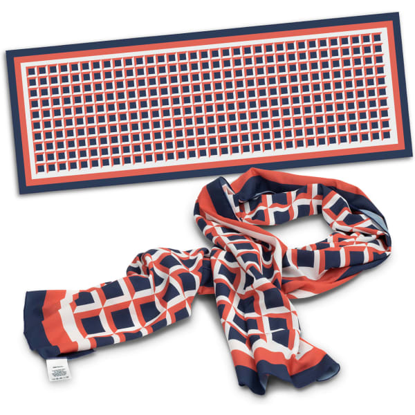 A long scarf featuring a geometric pattern in red, navy, and white, with a branding tag.