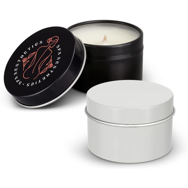 A black and a white tin candle with a lid, showcasing a minimalist design. The black tin features a logo.