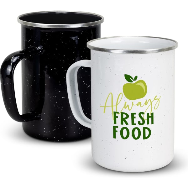 Two enamel mugs in black and white with silver rims; one features a green apple graphic and text.