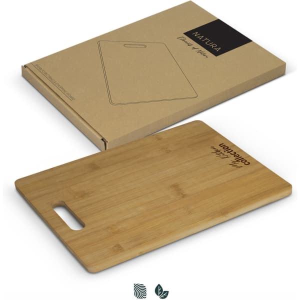 A bamboo rectangle chopping board displayed on a kraft paper box, featuring a handle and natural wood colour.