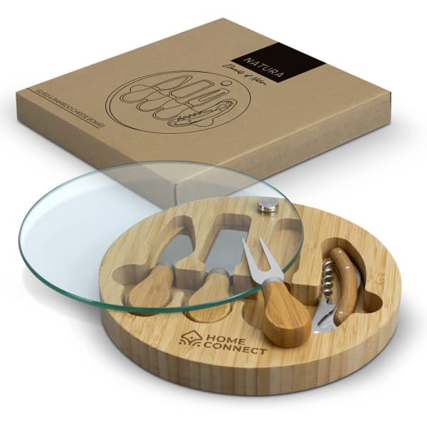 A bamboo cheese board with a glass top and wooden utensils, featuring a logo on the board.