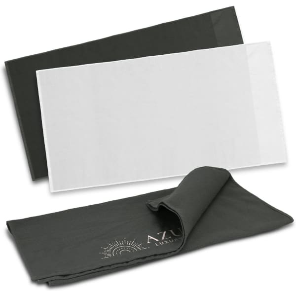 Two waffle towels are displayed, one in dark green and one in white, with a logo on the dark green towel.