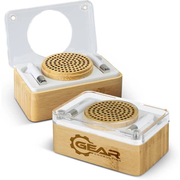 A bamboo wireless speaker and earbud set with a clear lid, featuring a logo on the side.