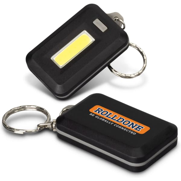 A black key ring light with a COB light and a metal keychain, featuring a logo on one side.