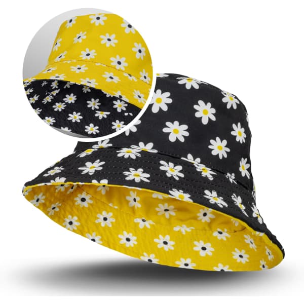 A reversible bucket hat featuring a yellow floral pattern on one side and a black floral pattern on the other.