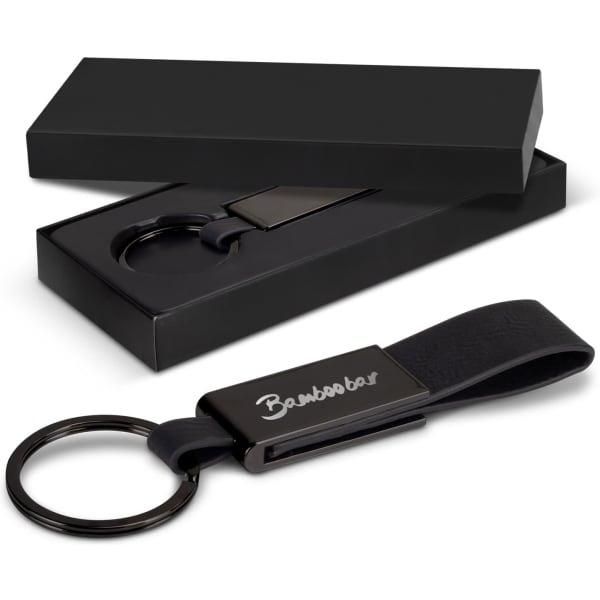 A black key ring with a polished metal clip, displayed alongside its black gift box.