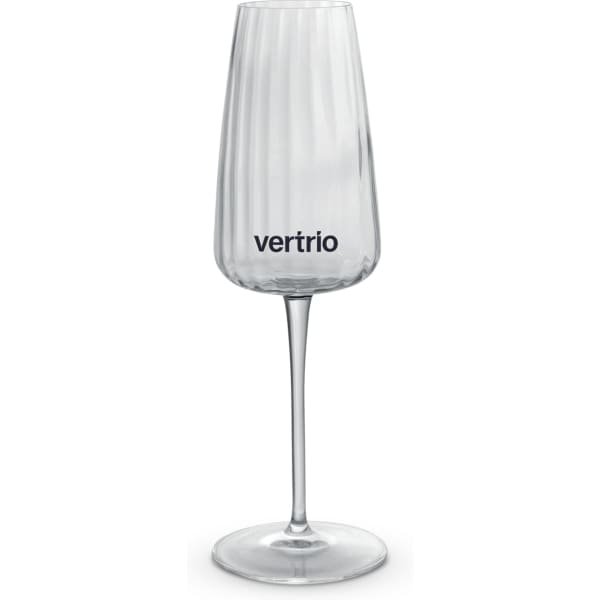 A clear, elegant flute glass with a ribbed design and a logo on the side, set against a white background.