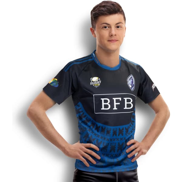A man wearing a custom men's rugby performance T-shirt in shades of blue with a logo and decorative patterns.