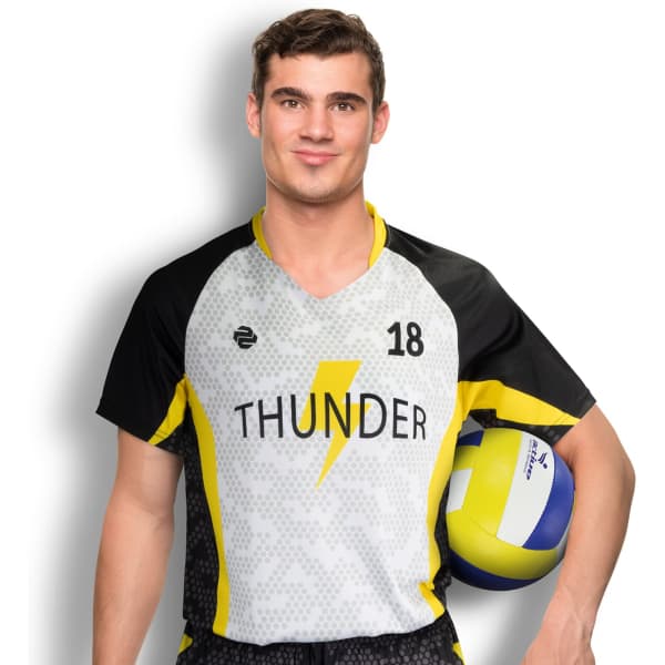 A man in a grey and black volleyball jersey with yellow accents, holding a volleyball. The jersey features a logo.