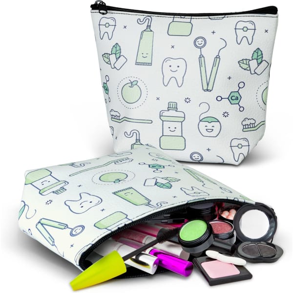 A small white cosmetic bag featuring a playful pattern of dental and beauty items, packed with various makeup products.