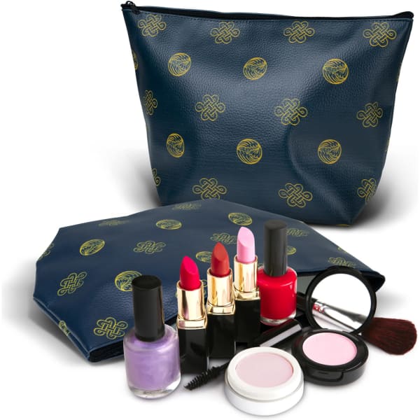 A navy cosmetic bag with a gold pattern, accompanied by various makeup products including lipsticks, nail polish, and compact.