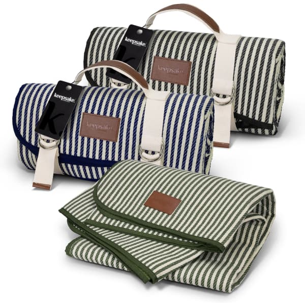 A folded picnic blanket in navy and white stripes, and a green and white striped blanket, both with branding.