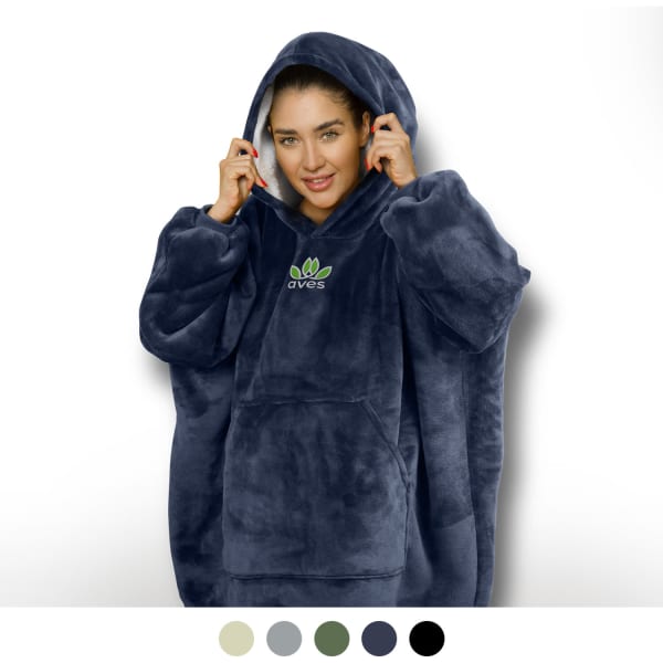 A woman wearing a navy blue hoodie blanket with a large hood and a front pocket, featuring a logo.