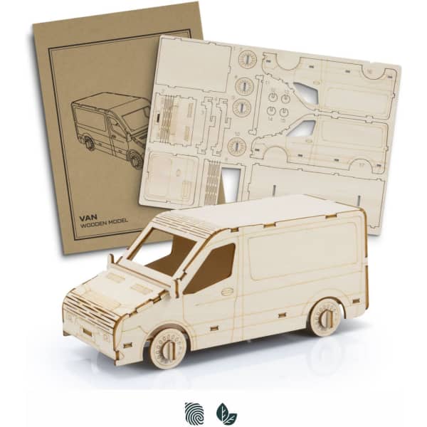 A wooden model van in natural wood colour with assembly instructions. The model features detailed cutouts and wheels.