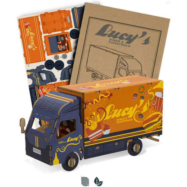 A wooden model of a small truck in blue and orange, accompanied by a set of craft materials and instructions.