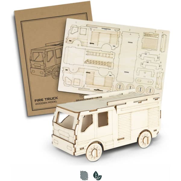 A wooden model of a fire truck, featuring detailed cut-outs and assembly instructions on a backing sheet.