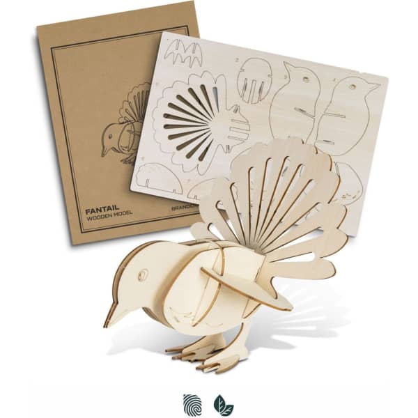 A wooden model of a fantail bird with intricate cut-outs, accompanied by a packaging design featuring similar bird illustrations.