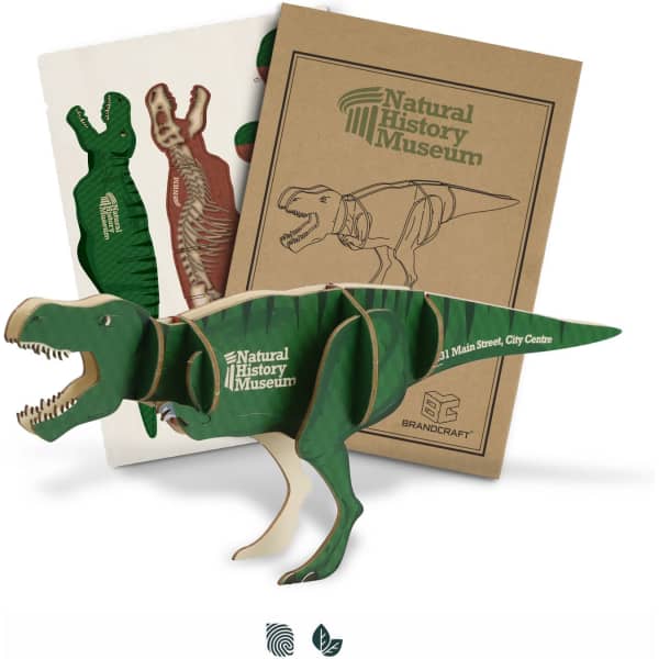 A green wooden Tyrannosaurus Rex model accompanied by instructional sheets and a logo.