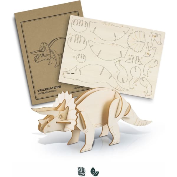 A wooden triceratops model in natural wood, alongside pre-cut pieces for assembly and a branded instruction sheet.
