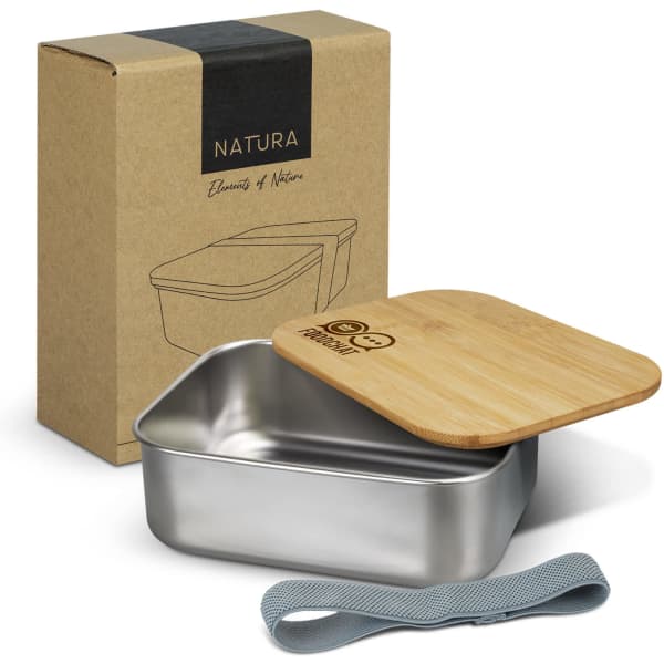 A stainless steel lunch box with a bamboo lid, surrounded by a grey elastic strap and packaging.