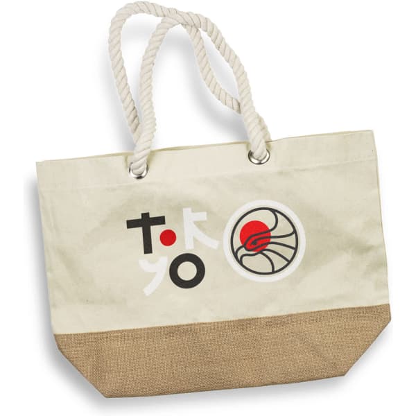 A cream tote bag with a jute bottom, featuring a logo and colourful graphics. It has sturdy rope handles.