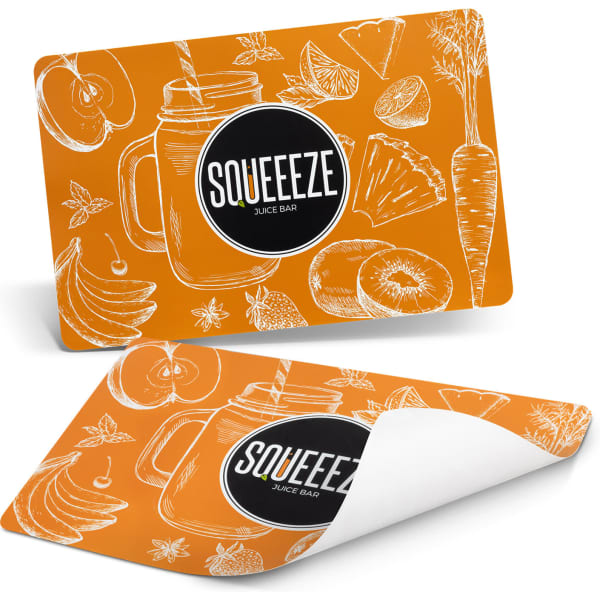 An orange place mat featuring hand-drawn fruits and vegetables with a logo.